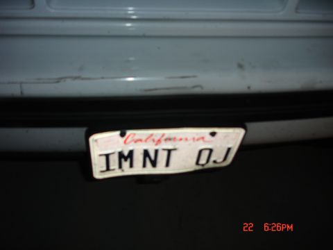 1996 Ford Bronco - Close-up of a California license plate on the rear of a white vehicle.