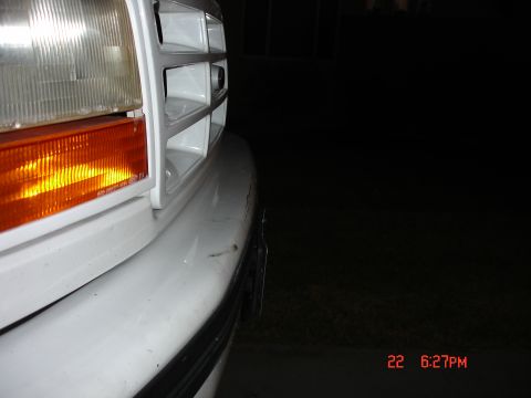 1996 Ford Bronco - Close-up of a white truck's front end, showing the grille and headlight assembly, indicative of a 1992 model.