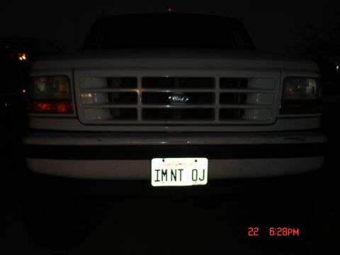 1996 Ford Bronco - Front view of a white 1996 Ford Bronco, its grille and a personalized California license plate.