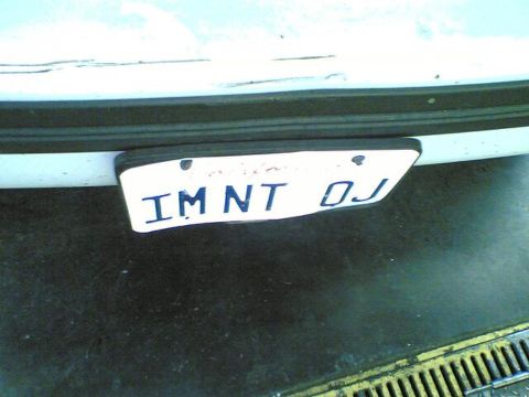 1996 Ford Bronco - A license plate reading "IM NT DJ" is attached to the rear of a white vehicle.