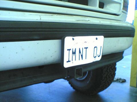 1996 Ford Bronco - The rear of a white SUV is shown, with a license plate and trailer hitch.