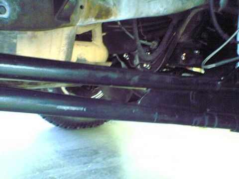 1996 Ford Bronco - Close-up view of the underside of a vehicle, showing suspension and exhaust components.