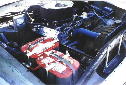 1979 Ford Bronco - Engine bay view shows dual red top batteries and custom blue hoses.
