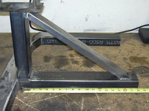 1991 Ford Bronco - A shop-fabricated bracket welded from square steel tubing with a gusseted diagonal brace and a flat mounting plate at the top, sitting on a…