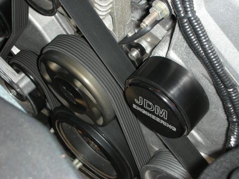 1998 Ford Crown Victoria - close-up of black accessory pulleys driven by serpentine belts, with one branded JDM Engineering.
