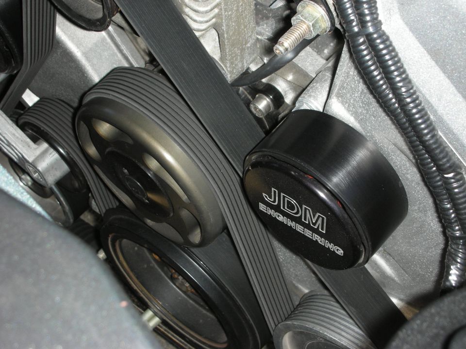 Close-up of black JDM Engineering pulley and serpentine drive belts