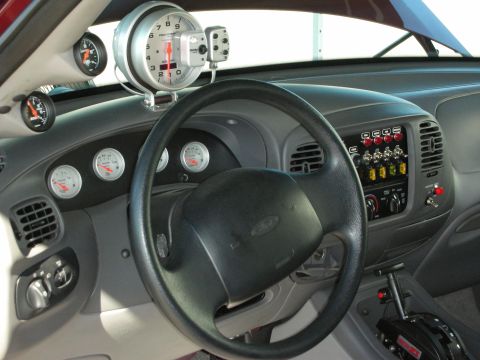 1998 Ford Crown Victoria - custom interior with a Ford steering wheel, multiple round gauges, a roll bar and a tachometer mounted atop the dash.