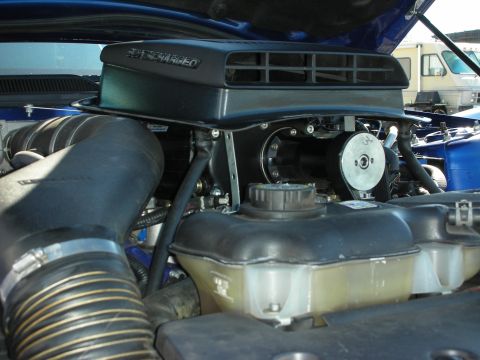 1998 Ford Crown Victoria - engine bay showing a black supercharger air box mounted above a blue painted motor.