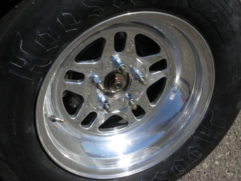 1998 Ford Crown Victoria - close-up of a polished aluminum drag wheel fitted with a Hoosier slick tire.