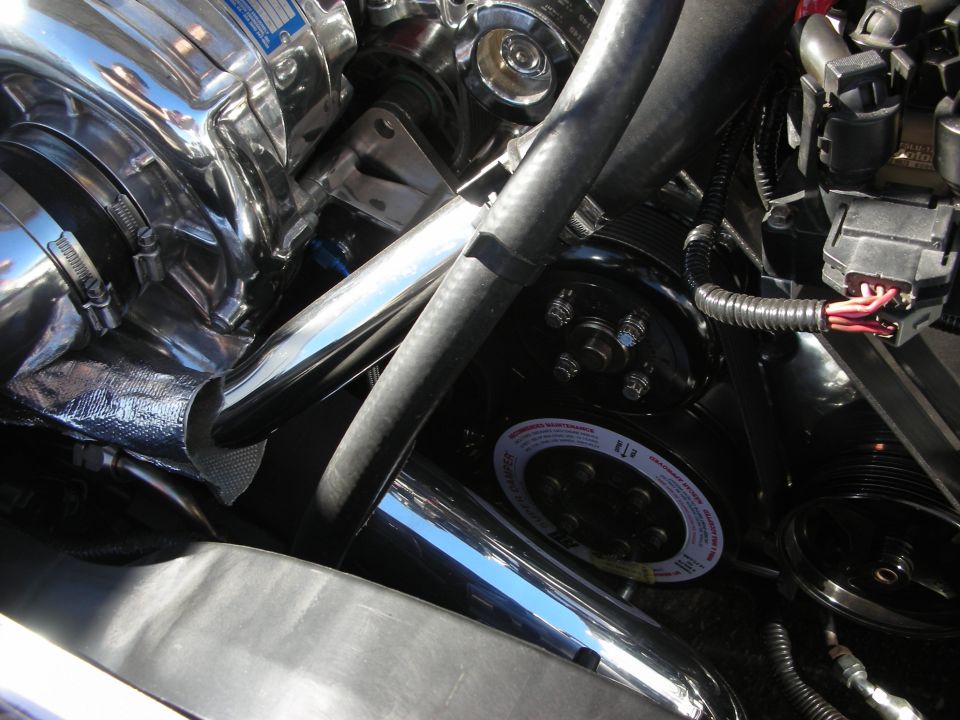 Engine pulleys, belt and chrome tubing in a detailed engine bay