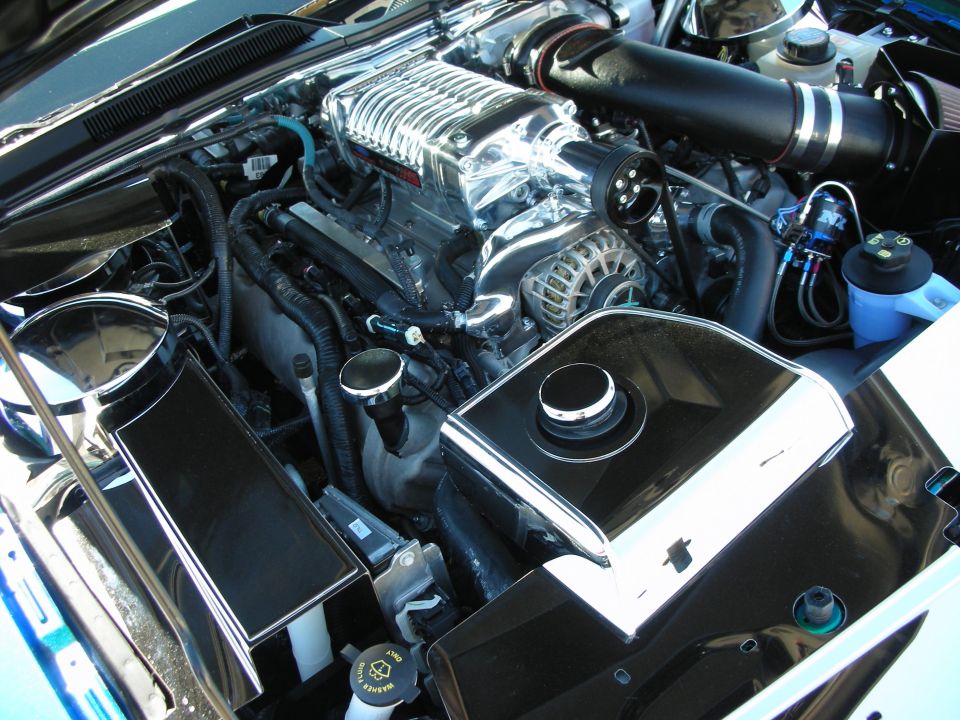 Modified engine bay with supercharger and polished intercooler piping