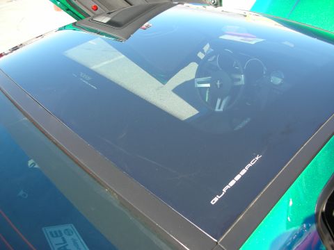 1998 Ford Crown Victoria - Glassback rear window of a custom Mustang reflecting the steering wheel and gauges, marked GLASSBACK.