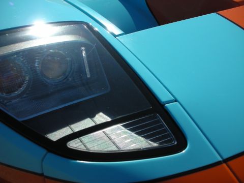 1998 Ford Crown Victoria - Detail of a Ford GT projector headlight set into light-blue and orange Gulf-style bodywork.