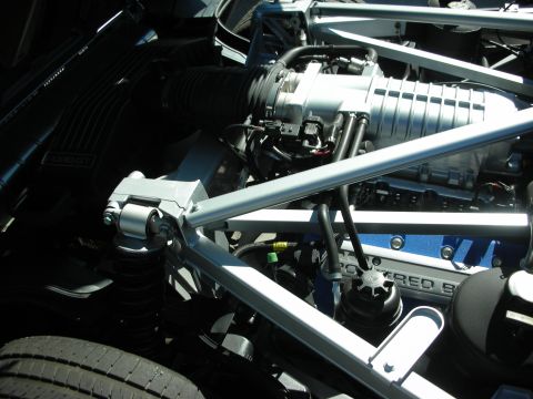 1998 Ford Crown Victoria - Supercharged engine and structural silver chassis tubes visible in a Ford GT engine bay.