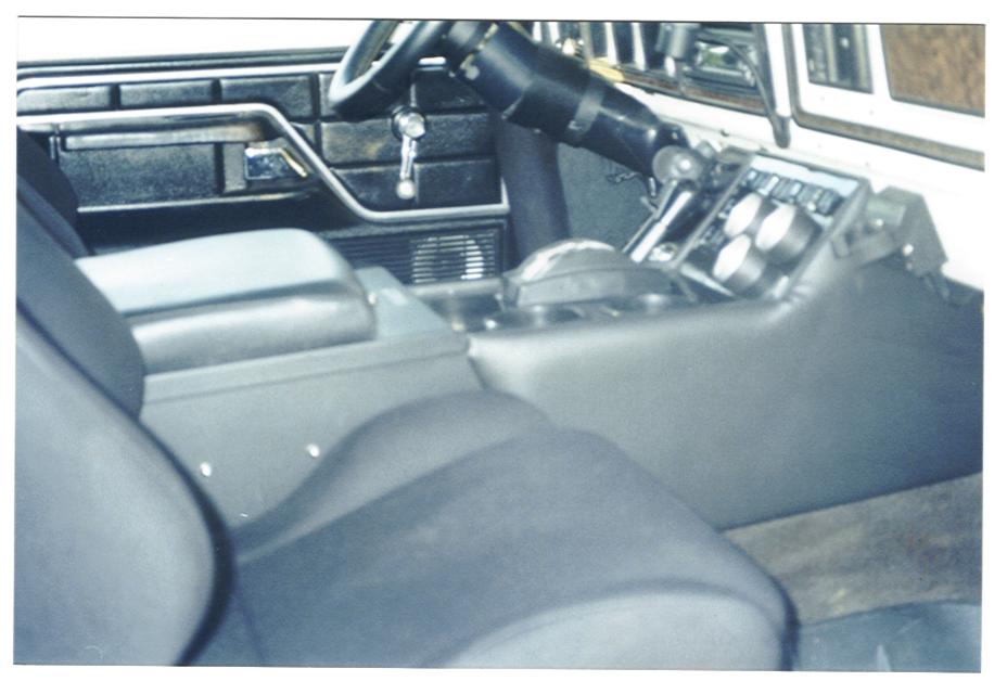 Black vehicle interior with dash, console shifter, and seats