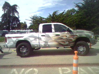 1994 Ford Bronco - This pickup truck has a unique camouflage and flame graphic design on its body.