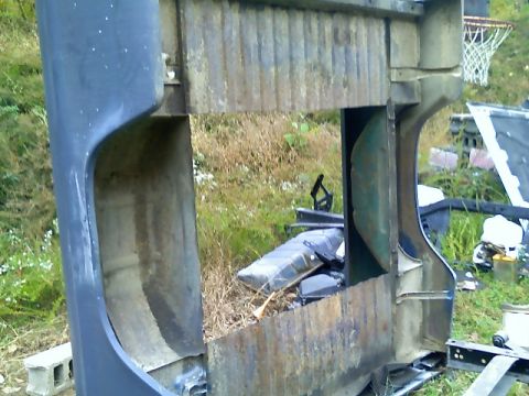 2002 Ford Crown Victoria - This appears to be a rusted metal frame, possibly part of a larger structure, with a basketball hoop visible in the background.