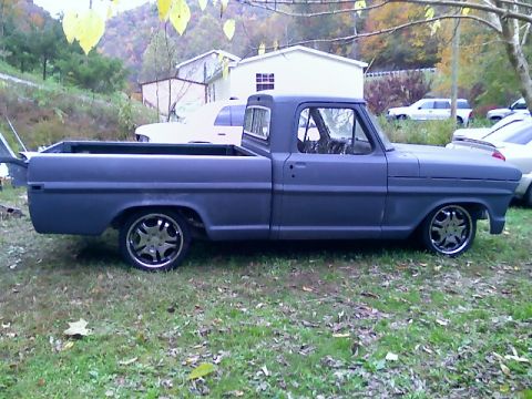 2002 Ford Crown Victoria - This pickup truck, likely a 1967 Ford F-100, is shown in a side profile with a lowered stance and aftermarket wheels.