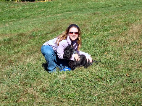 1985 Ford LTD Crown Victoria - Woman and her dog enjoying a sunny day outdoors on a grassy hill.