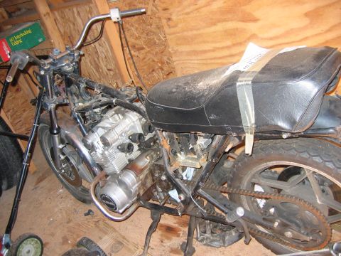 1985 Ford LTD Crown Victoria - This motorcycle appears to be in a state of disrepair or disassembly, with its engine and frame components visible.