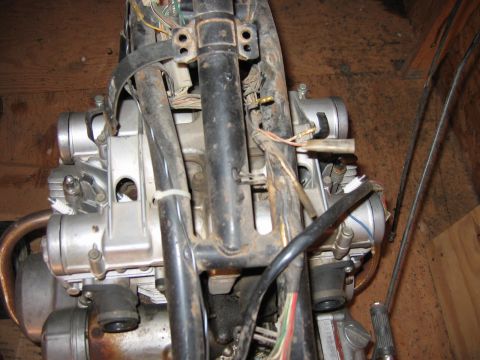 1985 Ford LTD Crown Victoria - Close-up view of a disassembled motorcycle engine, showing its internal components and wiring.