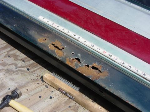 1991 Ford Bronco - Metal panel shows significant rust damage, with tools laid out for restoration.