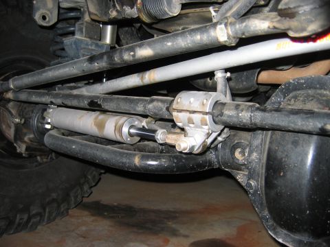 1985 Ford Bronco - Close-up view of a hydro assist steering cylinder and linkage assembly, likely for an off-road vehicle.