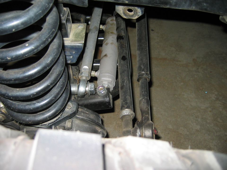 Undercarriage view of coil spring, shock absorber, and suspension links