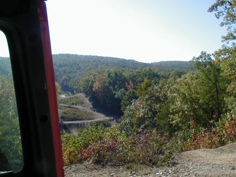2005 Jeep Wrangler - Off-road trail scenery viewed from inside a vehicle, with a Supermotors.net watermark.