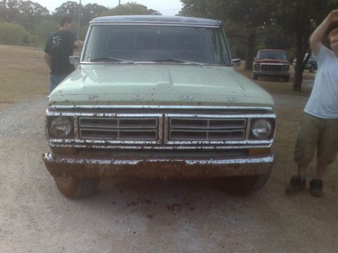 1991 Ford Bronco - Mud-covered Ford truck with a distinctive grille, suggesting a 1970s model year, is parked outdoors with another vehicle behind it.