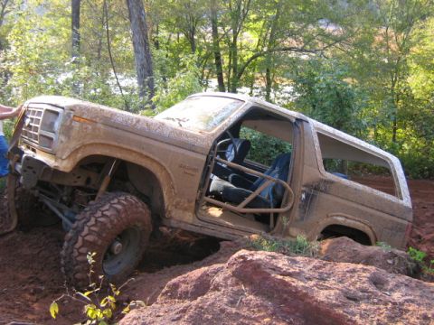 1986 Ford Bronco - This heavily modified SUV is stuck in the mud, its body style suggesting an early 1980s model.
