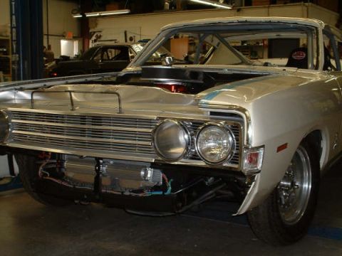 2005 Ford Mustang - A 1969 Ford Torino is shown with its hood open, revealing the engine bay and front grille.