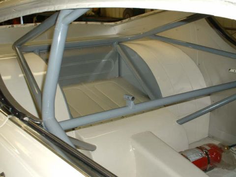 2005 Ford Mustang - Car interior shows a roll cage and a fire extinguisher, but year and model are not identifiable from this view.
