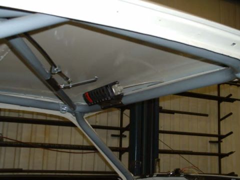 2005 Ford Mustang - Interior view of a vehicle's roll cage and roof lining, with a black electrical component mounted.