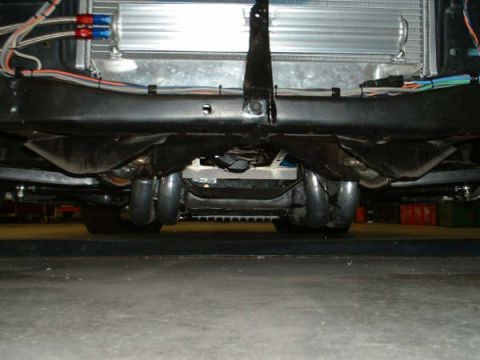 2005 Ford Mustang - The underside of a vehicle is visible, showing dual exhaust pipes and a radiator assembly.