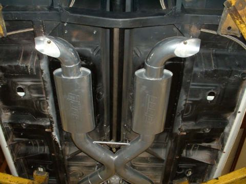 2005 Ford Mustang - Underside view of a vehicle's dual exhaust system with polished mufflers and angled tips.