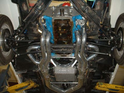 2005 Ford Mustang - Undercarriage view reveals custom exhaust headers and engine block details, with SuperMotors branding.