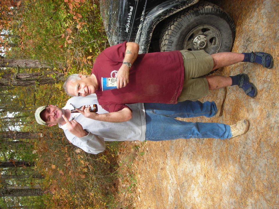 1997 Jeep TJ side view with two men standing next to it, one holding a beer