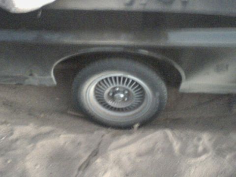 1972 Ford Ranchero - A portion of a vehicle's side, focusing on the rear wheel and fender well.