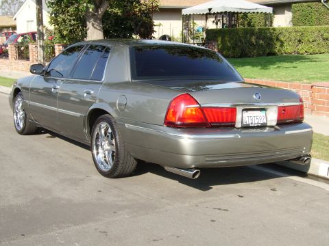 2000 Mercury Grand Marquis - This Mercury Grand Marquis features a distinctive rear end with large taillights and dual exhaust pipes.