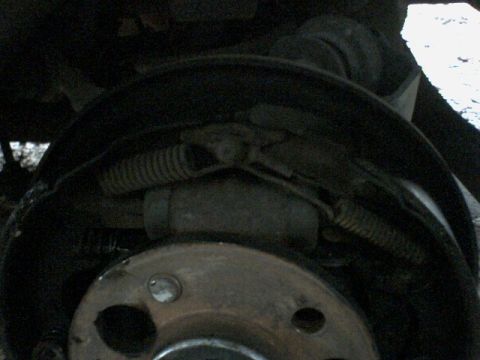 1972 Ford Ranchero - Close-up view of a vehicle's drum brake assembly, showing internal components like springs and brake shoes.