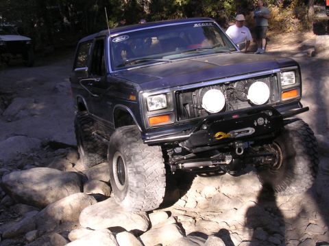1985 Toyota 4Runner - This modified Ford Bronco navigates a rocky trail, demonstrating its off-road capabilities.