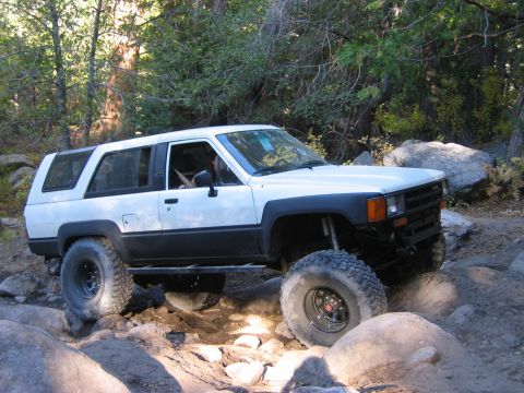 1985 Ford Bronco - This modified 1984 Toyota 4Runner navigates a rocky trail with large off-road tires.