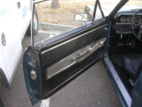 1975 Ford Ranchero - Interior view of a 1966 Ford Falcon, showing the driver's side door panel and dashboard.