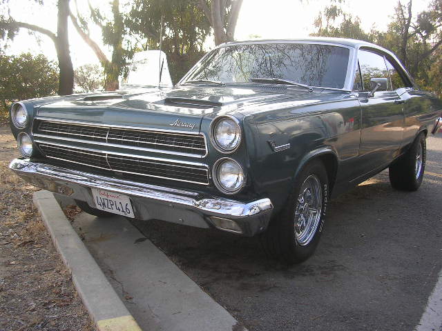 Green Mercury Comet parked on a curb. License plate reads 4WZP416