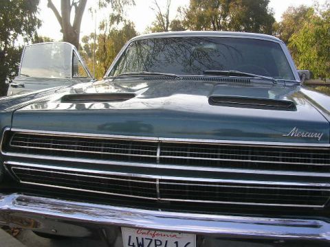 1975 Ford Ranchero - The front of a green Mercury Ranchero is shown with its grille and hood scoop visible.