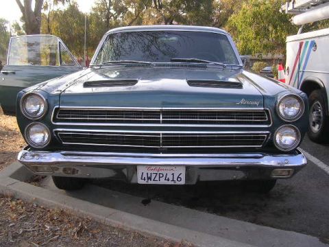 1975 Ford Ranchero - Front view of a green 1966 Mercury Comet, a prominent chrome grille and dual headlights.