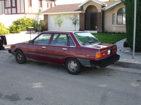 1993 Ford Taurus - This maroon sedan, seen from the side, appears to be from the early 1980s, not a 1993 Ford Taurus.