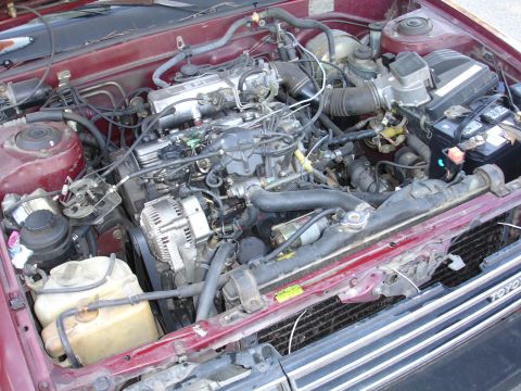 1993 Ford Taurus - Close-up view of a car's engine bay, showing various components and wiring.