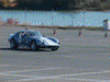 2001 Mercury Grand Marquis - A Porsche 911 navigates a cone course on a sunny day.